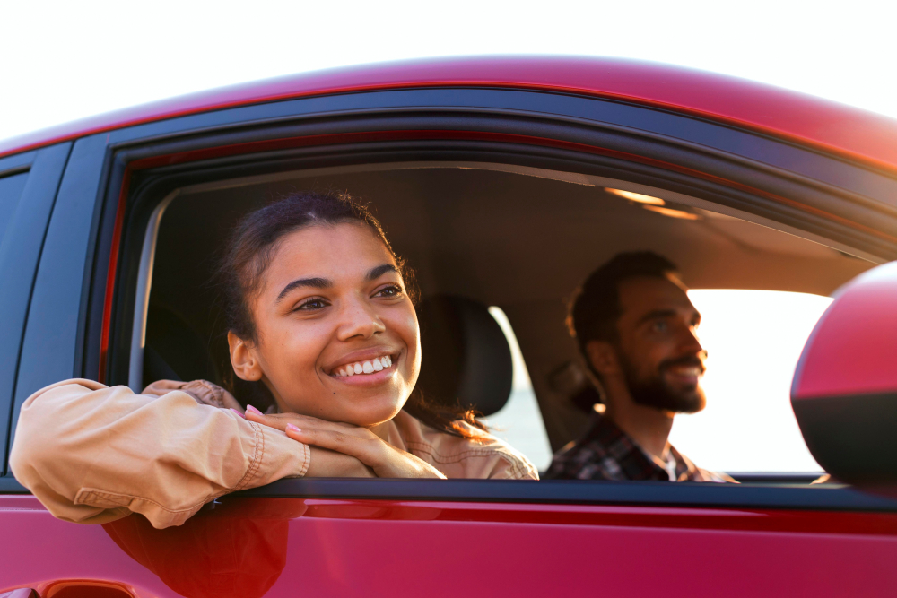 Smiling couple traveling by car.